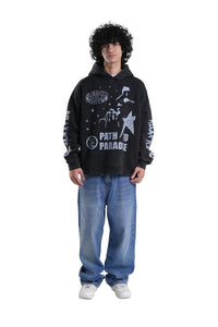 Person wearing a black hoodie with white text and graphics on a gray background